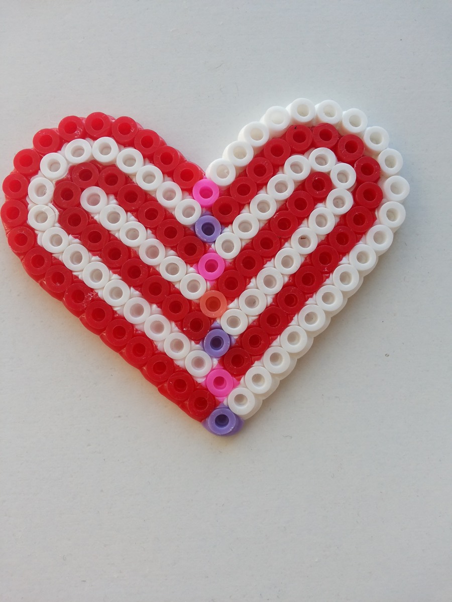 Real photograph of the bead-facing side of a red and white fused heart