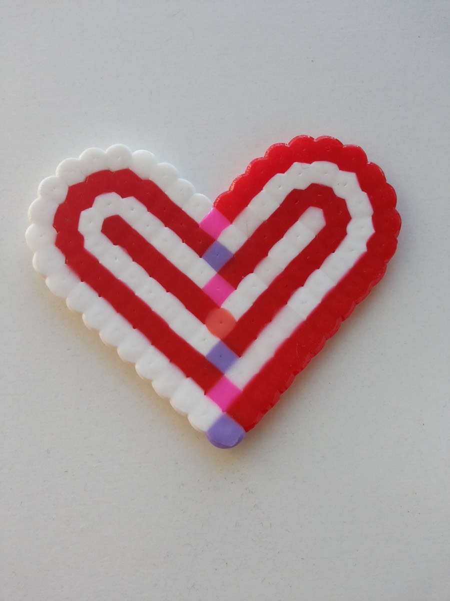 Real photograph of the heat-fused surface of a red and white bead heart